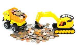 Truck and bulldozer toy loading coins money isolated on white